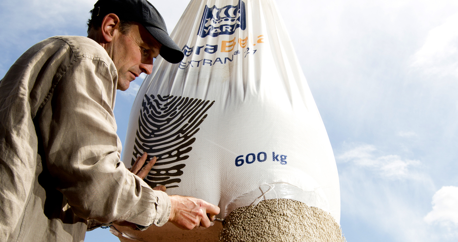 Farmer opening up a  yara fertiliser bag 