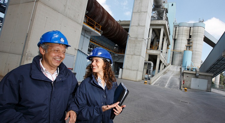 2 people at cement plant walking