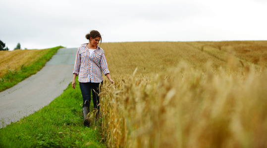 Female farmer walking within a field 